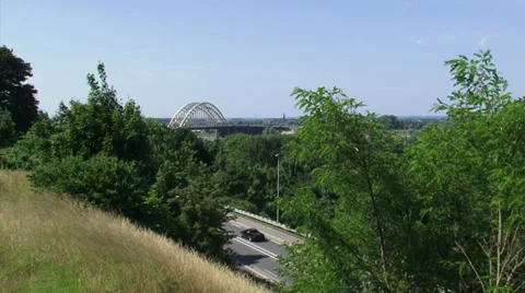 High angle view from moraine hill at road, traffic + arch bridge Waalbrug Stock Footage 27818008