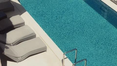 High angle view of mosaic pool and loungers in summer Видео 329412884