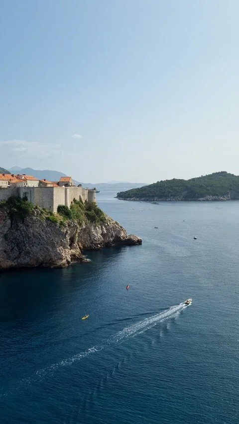 High angle view of a motorboat speeding near the historic Old Town, Dubrovnik. Stock Footage 335796348
