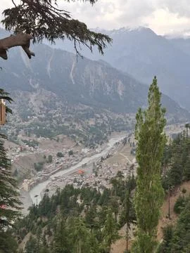 High angle view of mountain valley with river and green trees Stock Photos