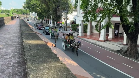 High angle view of a moving kalesa and motorcycle in Intramuros 4K Stock Footage 337457829