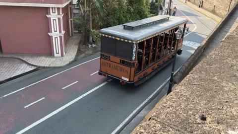 High angle view of a moving tourist tram bus in Intramuros Manila 4K Vídeos de archivo 337457865