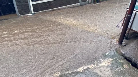 High angle view of muddy flood water flowing rapidly Stock Footage 323722033