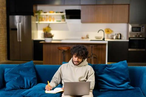 High angle view of the multi-ethnic Hindu freelancer guy using laptop computer 写真素材