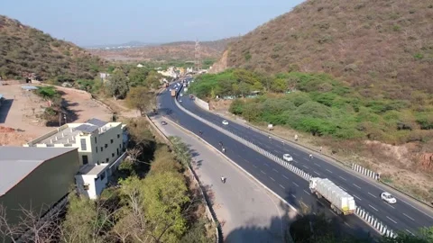High angle view of a multi-lane highway winding through a hilly landscape 動画素材 329854870