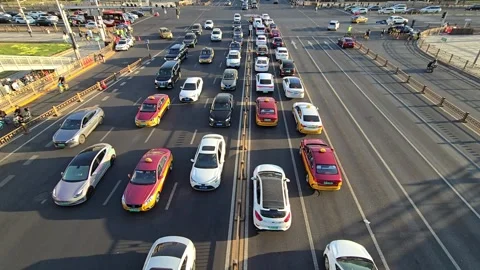 High angle view of multiple lanes of passenger cars and taxis queued at a tra Stock Footage 331594967