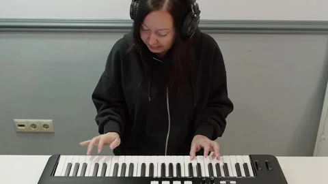 High angle view of musician singing while playing keyboard against wall Stock Footage 301273401