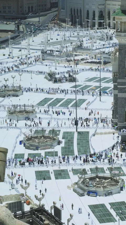 High-angle view of Muslim pilgrims gathered in the white courtyard of Masjid Stock Footage 340195052