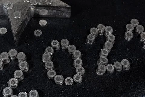 High angle view of New Years 2021 as Swiss coins on a black background. Stock Photos