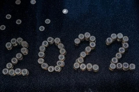 High angle view of New Years 2022 as Swiss coins on a black shiny background. Foto stock