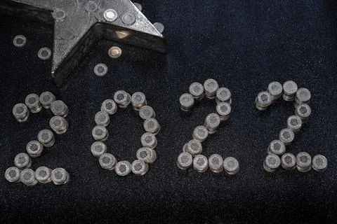 High angle view of New Years 2022 as Swiss coins on a black shiny background. Stock Photos