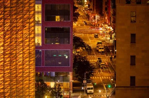 High angle view of night time New York city street buildings USPS trucks Stock Photos