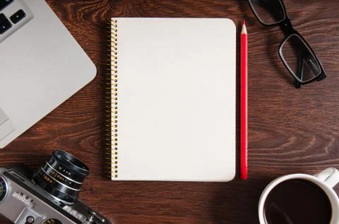 High angle view of notepad with copy space. Table with laptop and supplies. T Stock Photos