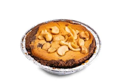 High angle view of nut chocolate cake in foil baking cup isolated on white. Stock Photos