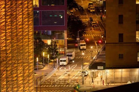 High angle view of NYC night time city street buildings USPS trucks Stock Photos