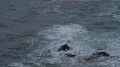 A high angle view of ocean waves breaking over rocks, Stock Footage 122104766