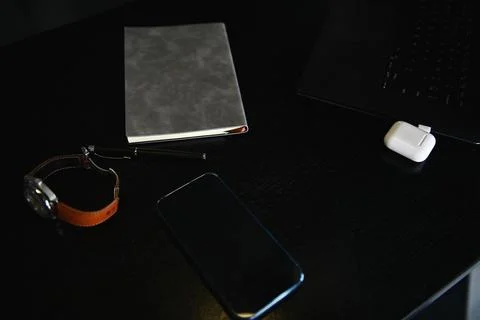 High angle view of office accessories, laptop, earphones on the box, watch, m Stock Photos
