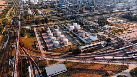 High angle view of oil refinery cylindrical storage tanks and railway track.. Stock Photos