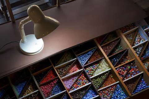 High angle view of the old retro desk lamp with various colorful beads in w.. Stock Photos