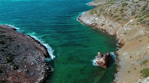 High-angle view of an old shipwreck resting in a turquoise cove near Stock Footage 346496121