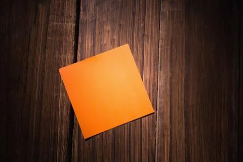 High angle view of orange blank adhesive note on wooden table, copy space Stock Illustration