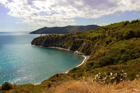 High angle view over Acquarilli Beach, a dark sand beach for nudist situated in Stock Photos