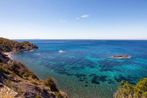 High angle view over Ogliera beach, a little wild free beach with dark sand Stock Photos