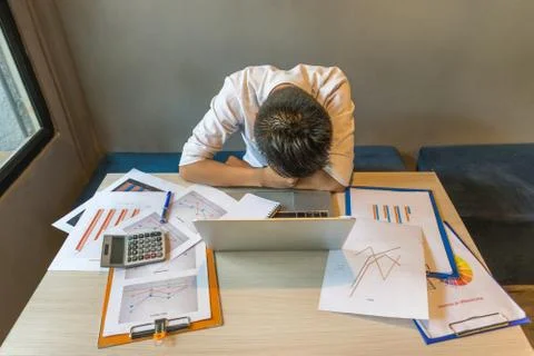 High angle view of overworking man fall asleep at office Stock-Fotos
