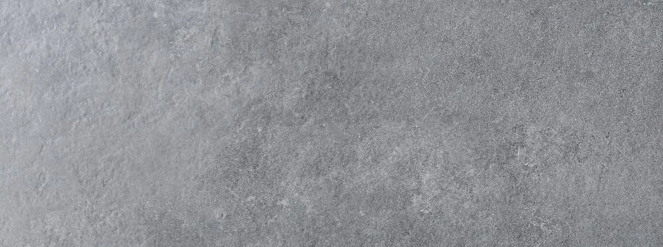 High angle view of a panoramic dark gray cement or concrete wall texture. Stock Photos