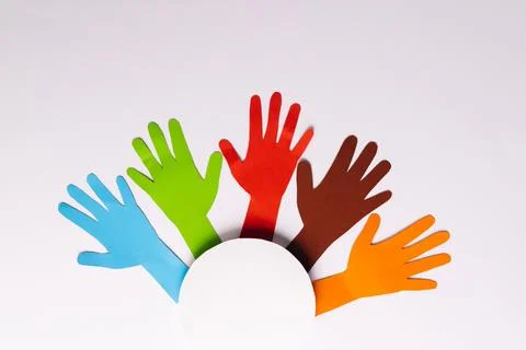 High angle view of paper multi coloured hands and white circle with copy space Foto stock