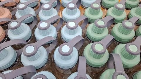 High angle view of pastel plastic drink bottles caps row Stock Photos