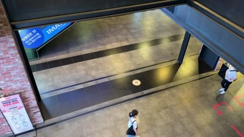 High-Angle View of Pedestrians in Cinema Complex with Signage Video stock 342333724