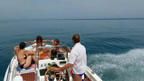 High angle view of people relaxing on motorboat on summer day slow motion 動画素材 279890725