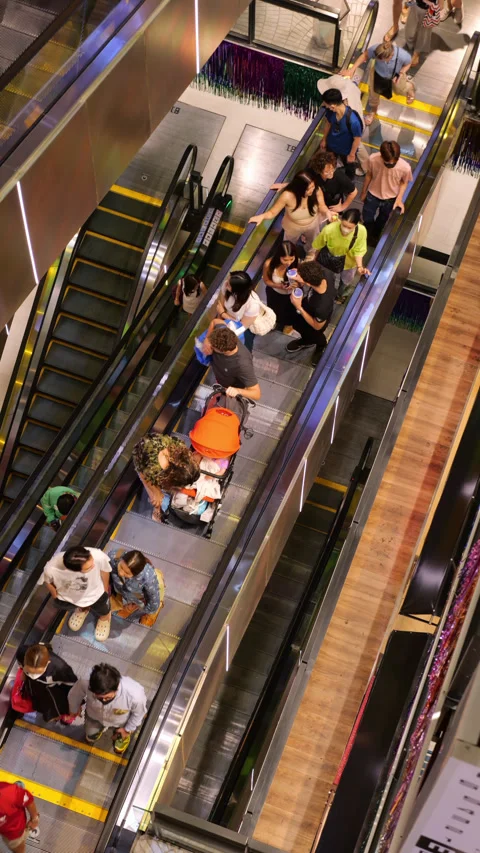 High angle view of people riding escalator in Bangkok shopping mall Stockbeeldmateriaal 326380841