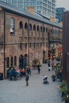 High angle view of people walking under the lights in Coal Drops Yard, London Stock Photos
