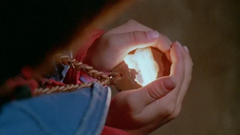 High angle view of person holding glowing magic stone necklace Stock Footage 95996531