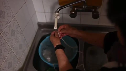 High angle view of a person washing tripe in the kitchen sink Video stock 320407474