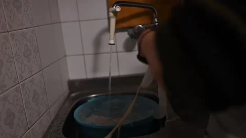 High angle view of a person washing tripe in the kitchen sink Video stock 320407477
