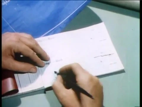 High angle view of person writing check in ledger Vídeos de archivo 58858851