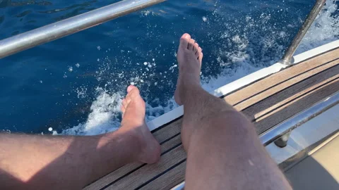 High angle view of persons legs sitting on motorboat deck and enjoying amazing Stock Footage 318648859