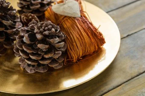 High angle  view of pine cones with thread in plate Stock Photos