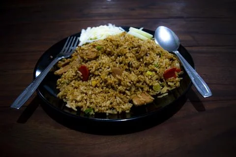High angle view of a plateful of fried rice on the wooden table Stock Photos