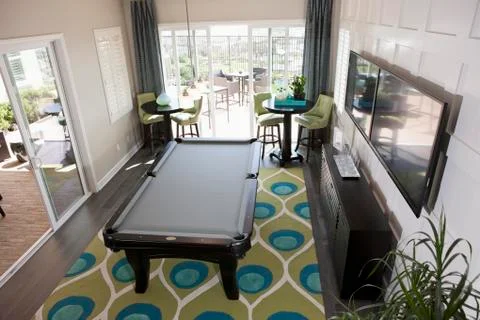 High angle view of pool table and televisions in games room Foto stock