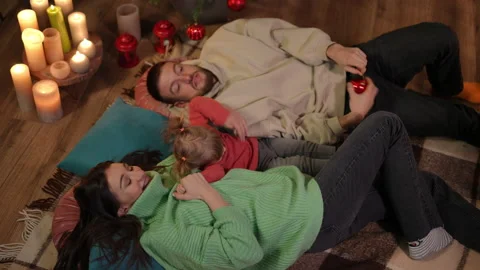High angle view of positive Caucasian young family lying at Christmas tree Video stock 219909539