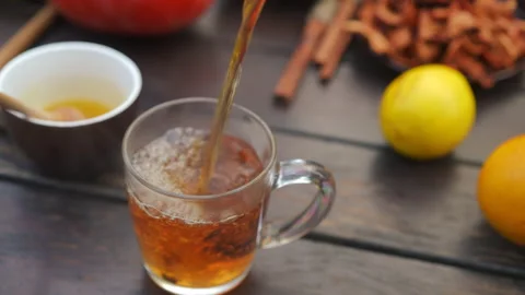 High angle view pouring green tea from teapot in cup outdoors. Unrecognizable Video stock 237511680