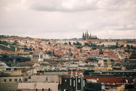 High-angle view of Prague red roofs and cathedral. Moody overcast sky over Stock Photos