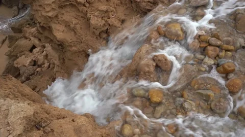 High-Angle View of Rapid Water Cascading Down an Eroded Rocky Dirt Cliff Vídeos de archivo 334182076