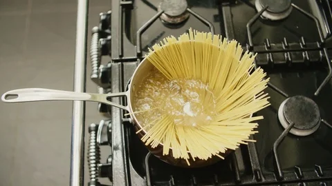 High Angle View Of Raw Pasta Cooking In Saucepan Stock Footage 86077757