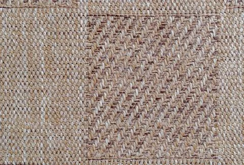 High angle view of a rectangular canvas sample patch on a woven beige texti.. Stock Photos