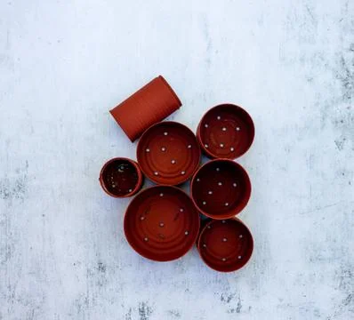 High angle view of red cans in different sizes with holes on the table Stock Photos